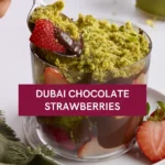 Dubai Chocolate Strawberries – Luxury You Can Taste at Home 8 A spoon lifting a strawberry coated in melted chocolate and crispy pistachio strands from a dessert cup labeled "Dubai Chocolate Strawberries