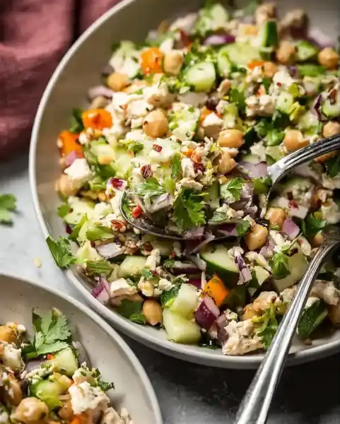 Jennifer Aniston Salad Recipe: Fresh, Protein-Packed & Actually Delicious 7 Mixing Jennifer Aniston Salad in a bowl