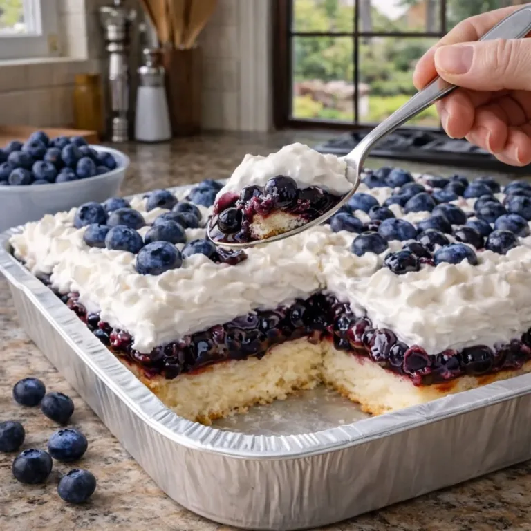 Delicious Blueberry Cloud Cake topped with fresh blueberries and cream